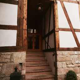 michelstadt oldtown entrance timberframed stairs historicalplaces historical olddoor oldhouse architecturephotography windows building dark middleages darkage flowers overgrown lantern